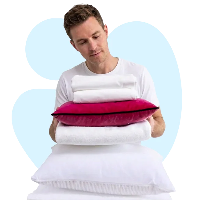 Stack of clean, fresh white towels and folded bed sheets